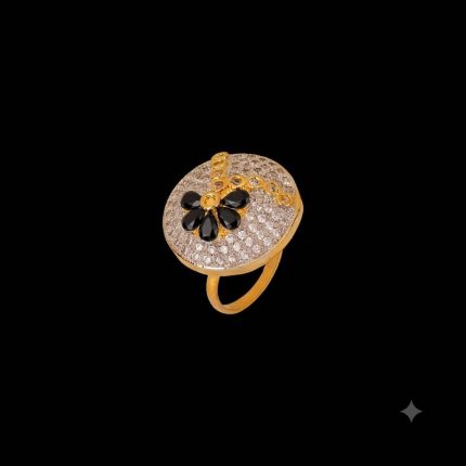 Large circular brass statement ring featuring gold and white dual-tone finish with a black floral stone design in the center