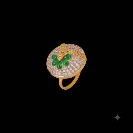Large circular brass statement ring featuring gold and white dual-tone finish with a green floral stone design in the center