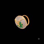 Large circular brass statement ring featuring gold and white dual-tone finish with a green floral stone design in the center
