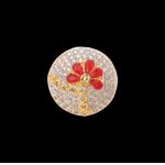 Large circular brass statement ring featuring gold and white dual-tone finish with a red floral stone design in the center