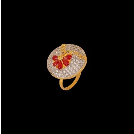 Large circular brass statement ring featuring gold and white dual-tone finish with a red floral stone design in the center