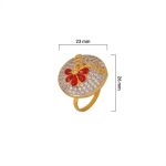 Large circular brass statement ring featuring gold and white dual-tone finish with a red floral stone design in the center